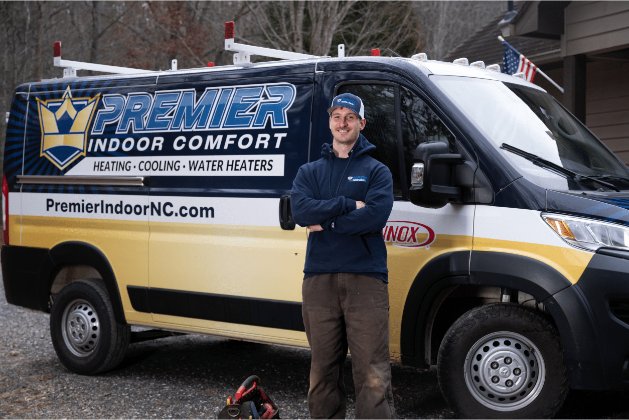 Man standing beside Premier Indoor Comfort Systems service van.